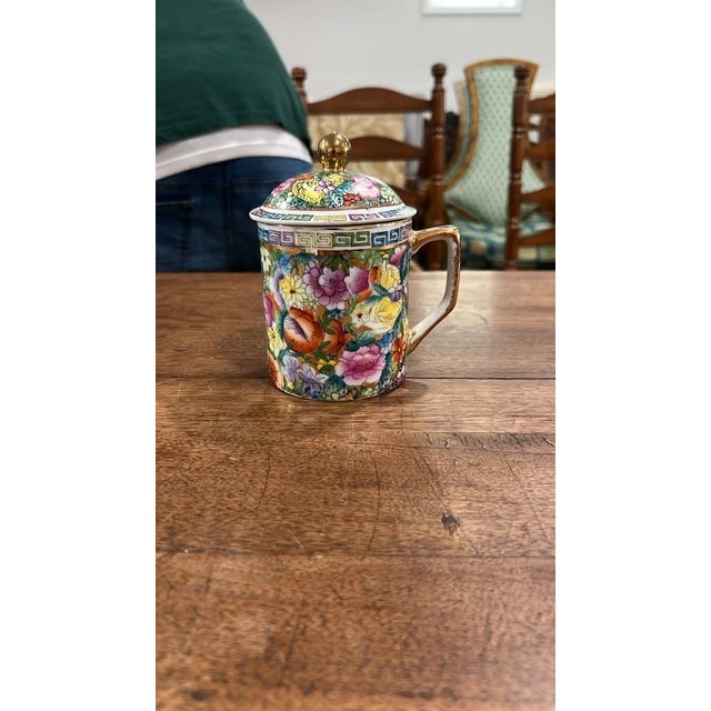 An ornate vintage Chinese porcelain tea mug with lid, decorated in the vibrant Millefleurs ("Thousand Flowers") Famille...