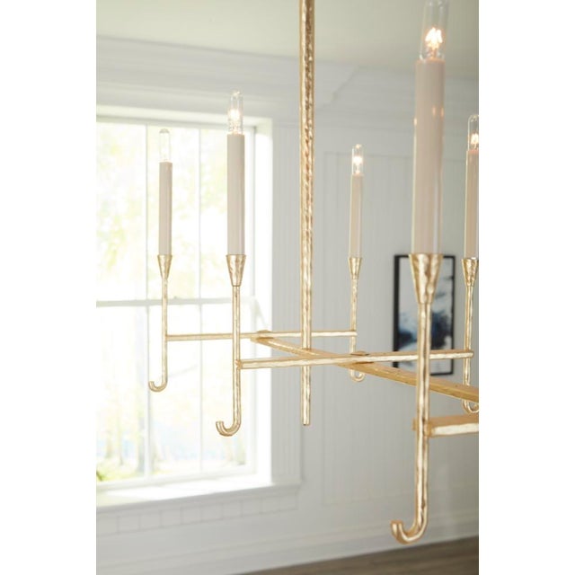 Hammered gold leaf over steel with eight electrified candles. 36.8h x 46.3w x 16d