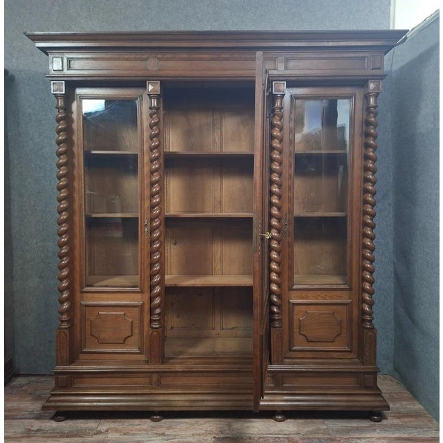 A substantial louis xiii style solid oak bookcase, dating from the 19th century. this generously sized piece is...