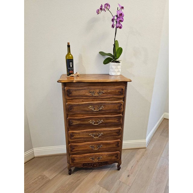 A vintage French Provincial walnut and oak semainier chest of drawers. Hand-crafted in France in the mid-20th century,...