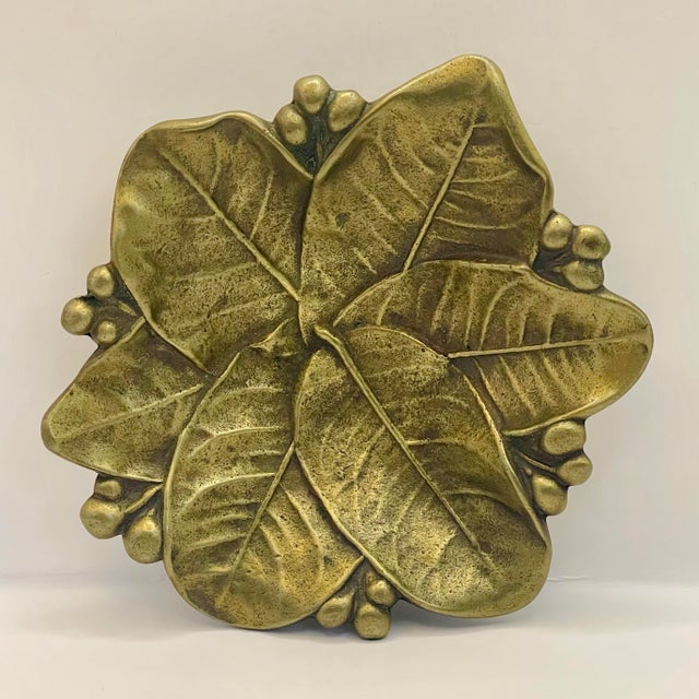 A mid 20th century brass footed dish shaped like a pile of fallen leaves trimmed with berries. Ships within 1-2 days using...