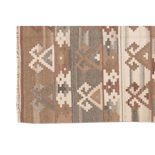 Beautiful Modern Kilim Hand-knotted wool rug with a ivory, brown, and gray field in-all-over geometric design. This rug...