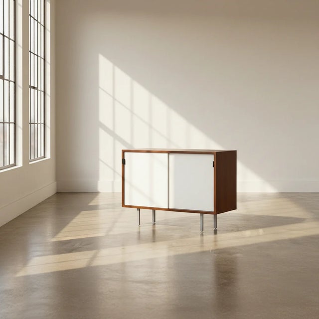 Classic Florence Knoll petite credenza from the 1950s. This 36"-wide piece features walnut construction with a rich patina...
