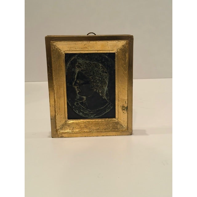 Handsome piece of antique art having a copper relief of Roman boy framed in a handsome giltwood molding.