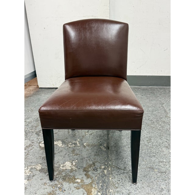 Design Plus Gallery presents a Leather Side Chair from Marco Furniture. The chair has brown leather upholstery, an arched...