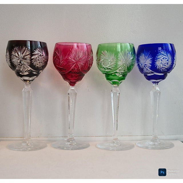 4 jewel tone crystal goblets cut to clear in American brilliant style. detailed stems and base. heavy. one very small flaw...