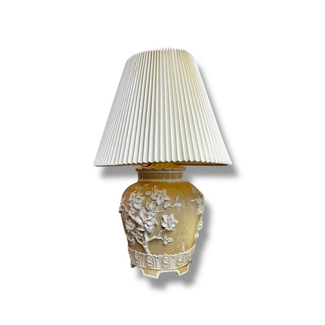 A timeless Chinoiserie pagoda-style table lamp featuring a beautifully detailed ceramic base in a warm golden hue. The...
