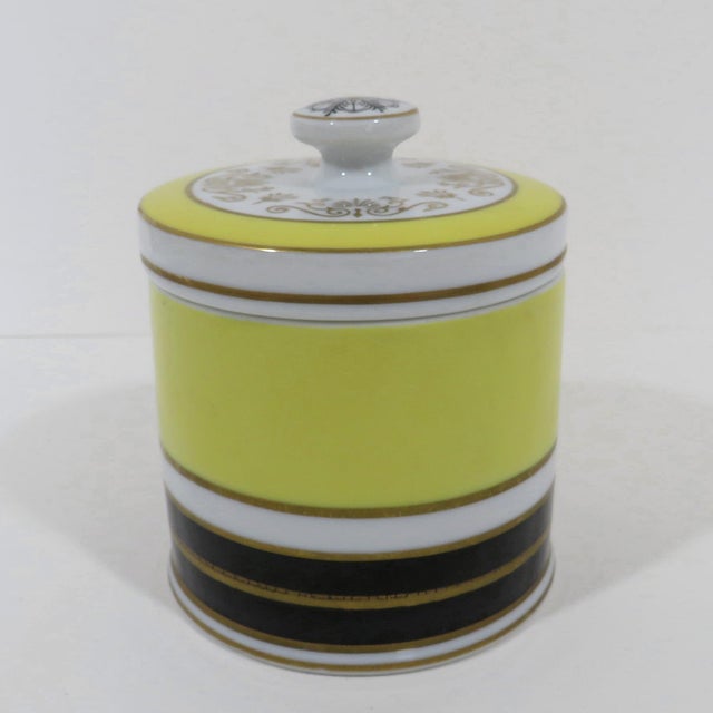Streamline style porcelain lidded jar by Mottahedeh, with bright lemon yellow bands and black, white and gold decoration....