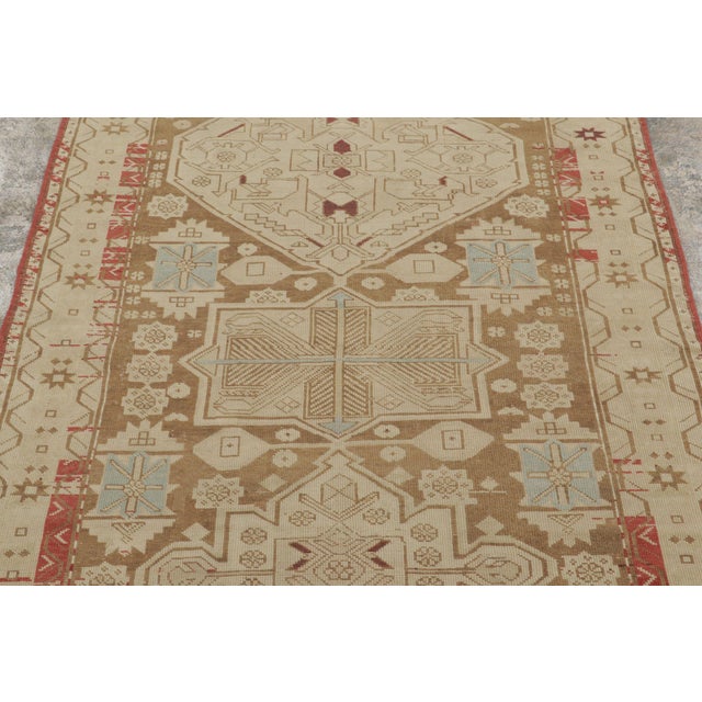 Hand-knotted in wool, this 4x10 antique Karabagh runner from the Southern Caucasus, circa 1900-1920, is a masterful find...