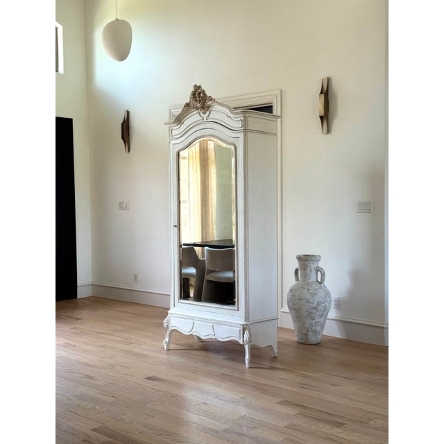 An exquisite 19th century French armoire showcasing masterful craftsmanship and timeless elegance. This stately piece...