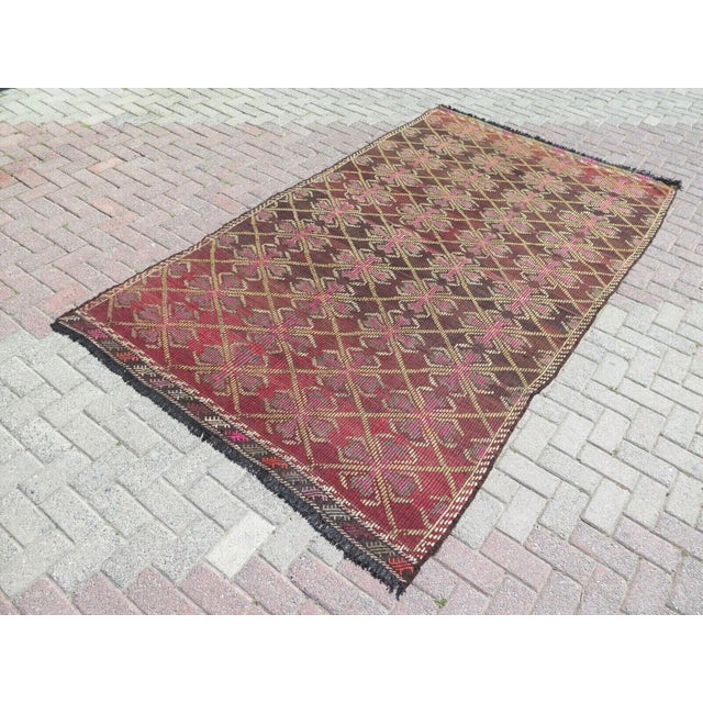 This beautiful, traditional vintage, hand knotted Turkish area rug is approximately 60 years old. It is handmade of very...