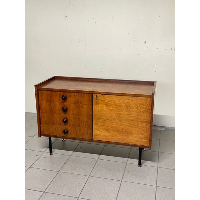 A small yet functional 1960s sideboard in perfect mid-century style, crafted in Italy. Made of teak, it features an...