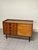A small yet functional 1960s sideboard in perfect mid-century style, crafted in Italy. Made of teak, it features an...