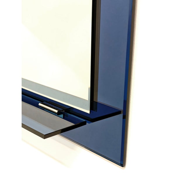 The mirror features a vintage Italian modern design, very popular in the 1970s. Its bold style and use of colored glass...