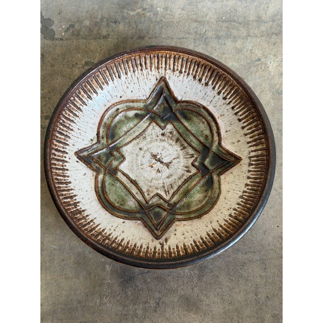 This vintage stoneware deep fruit bowl exhibits a classic circular form highlighted by an intricate incised geometric...