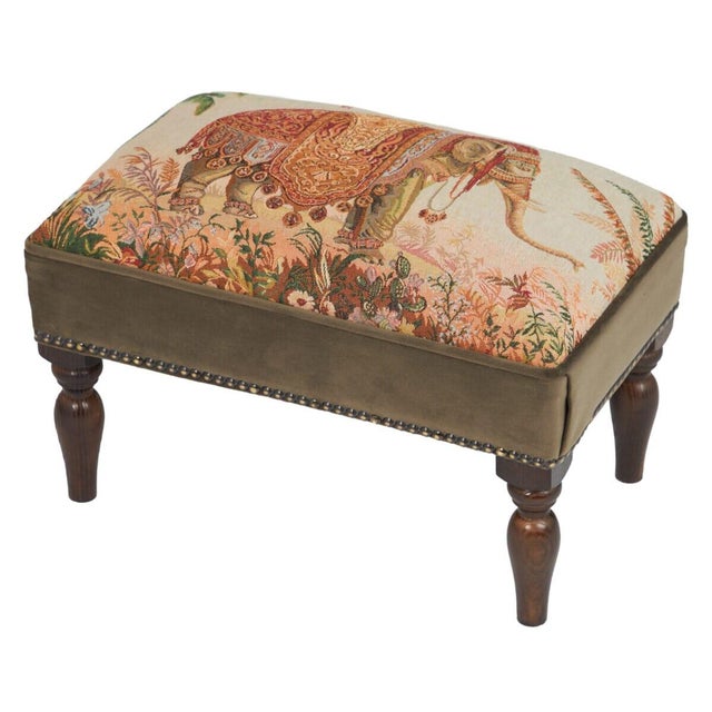 Meticulously handcrafted in the United Kingdom, this upholstered stool boasts classic studding and hand-polished solid...