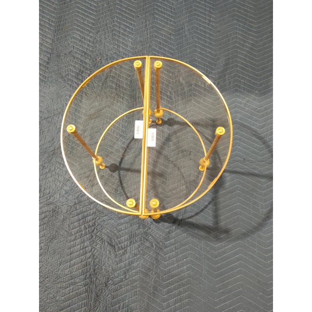 Elegant pair of French gilt brass demi-lune console tables, likely dating to the mid-20th century, executed in a refined...