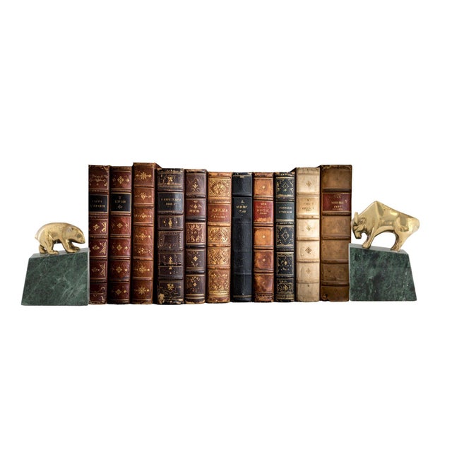 1980s Italian marble and brass bull and bear bookends celebrating the enduring symbolism of market optimism and caution....