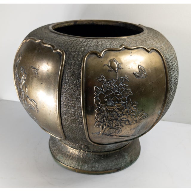 We are selling this bronze Chinese or Japanese planter. This planter vase is probably mid 20th century and has decorations...