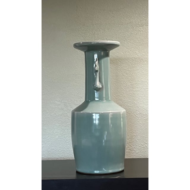 Presenting a substantial and beautifully crafted 18-inch tall celadon porcelain vase. This impressive piece features...