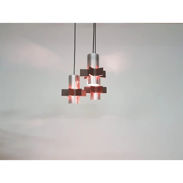 Aluminum Star Shaped pendant light, 1960s. 3 aluminum tubes with orange and brown star-shaped ornaments. In good working...