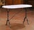Crafted in France circa 1920, this classic pastry table features a racetrack oval marble top resting on a sturdy iron...