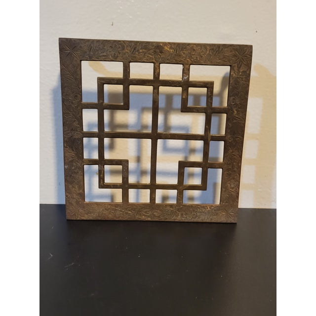 Lovely open work and etched brass trivet. The patina around the botanical etchings gives this piece a lot of character.