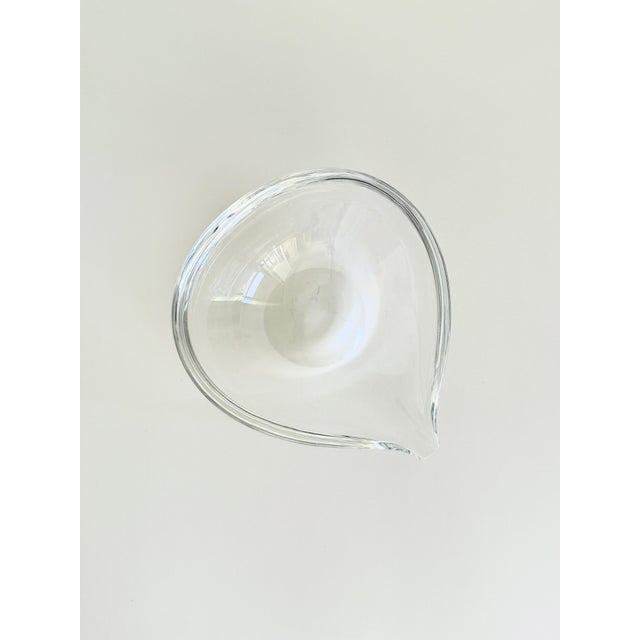 A large teardrop-shaped ashtray made by Steuben Glass circa 1990s. The piece is quite large and in addition to being a...