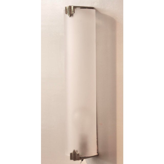 This French wall light probably comes from a cinema or hotel. The very elegant and reduced form consists of a pleated...