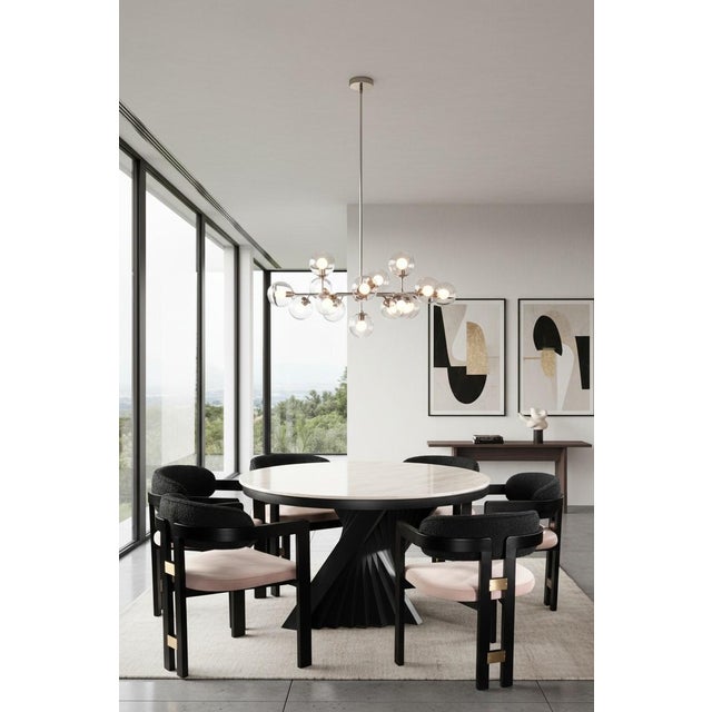 Sophisticated materials draw inspiration from modern geometry to create this stunning dining room set for six people. The...