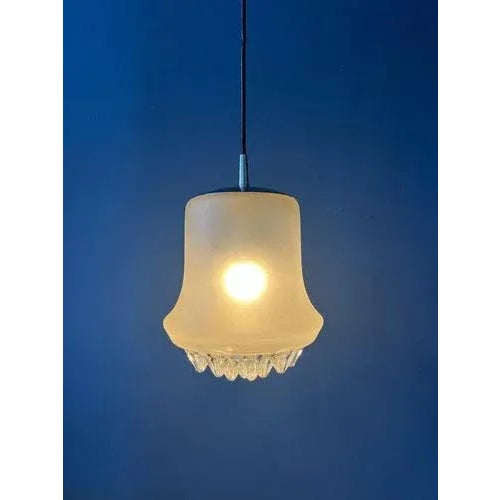 Unique mid century frosted glass pendant lamp by Peill & Putzler. The lamp has an icy look due to the frosted effect and...