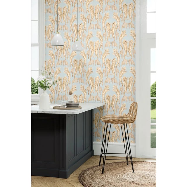 With its mica scales glimmering softly against a translucent painterly ground the formal art deco layout of this wallpaper...