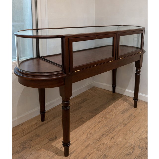 Gently used display case in an understated antique style with gorgeous bow end cabinet. The cabinet is constructed of...