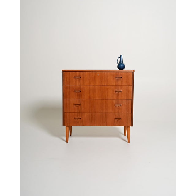 Teak chest of drawers with four drawers, recessed handles, and tapered legs. Made in Sweden, 1950s. Made in Sweden in the...