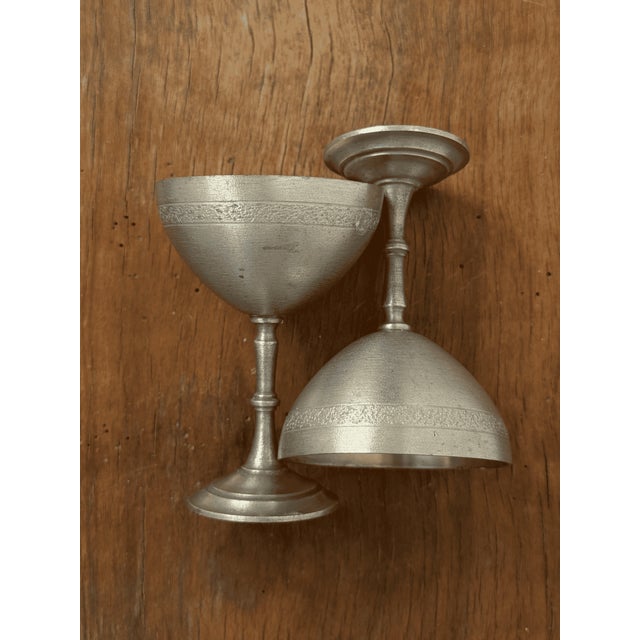 This pair of small goblets is crafted in solid pewter by Svenskt Tenn, the renowned Swedish interiors and metalware house....