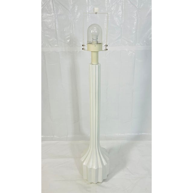 A striking vintage floor lamp defined by its architectural, sculpted column form and monolithic presence. Standing tall...