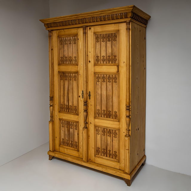 Gründerzeit softwood wardrobe featuring two doors and baluster-shaped column supports on the stiles and central divider....