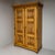 Gründerzeit softwood wardrobe featuring two doors and baluster-shaped column supports on the stiles and central divider....
