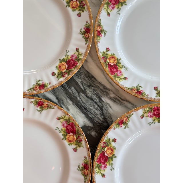 Presenting a set of eight dinner plates in the timeless, classic Old Country Roses pattern by Royal Albert. Each plate...