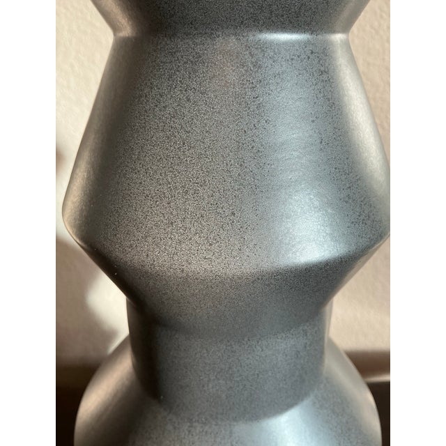 Modern West Elm sculptural ceramic vase featuring a bold geometric silhouette and sophisticated matte gray finish. The...