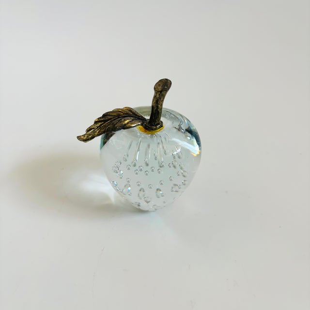 A vintage glass apple paperweight with a brass stem. Beautiful controlled bubbles to the center of the glass.