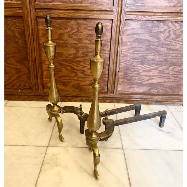 22” tall This striking pair of vintage andirons (also known as firedogs) blends classic design with sturdy functionality....