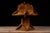 Mid-century handcrafted tramp art table lamp constructed from stained wood craft sticks arranged in repeating layered...