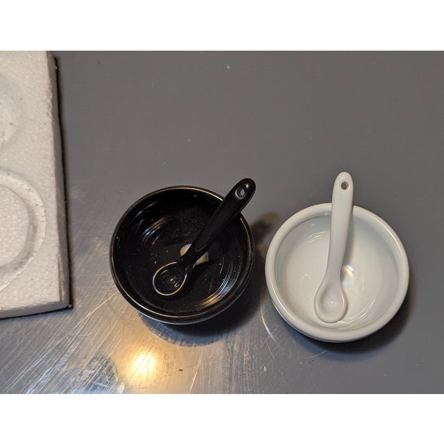 Shiny new looking black and white salt and pepper cellars with matching ceramic spoons. Discontinued and rare Pottery Barn...