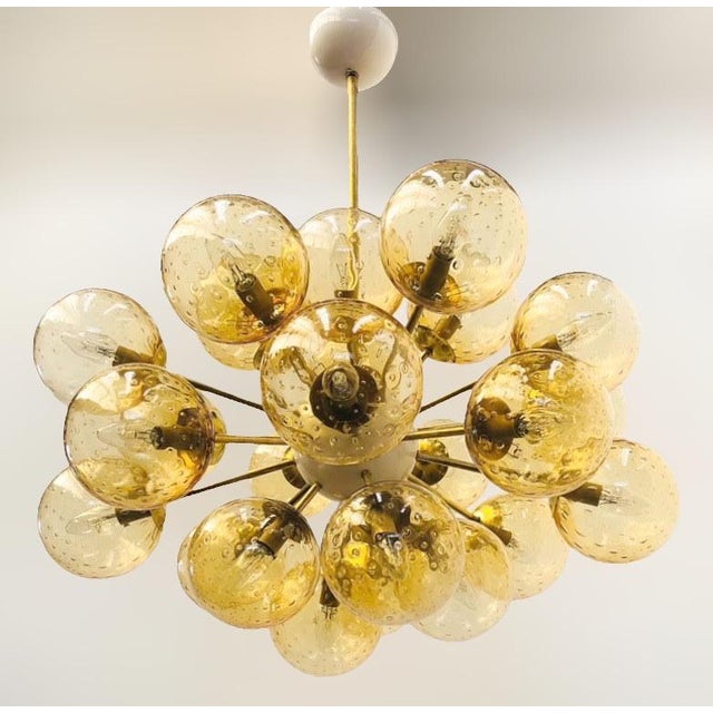 Italian oval shaped sputnik chandelier with 24 amber Murano glass globes carefully hand blown with bubbles inside the...