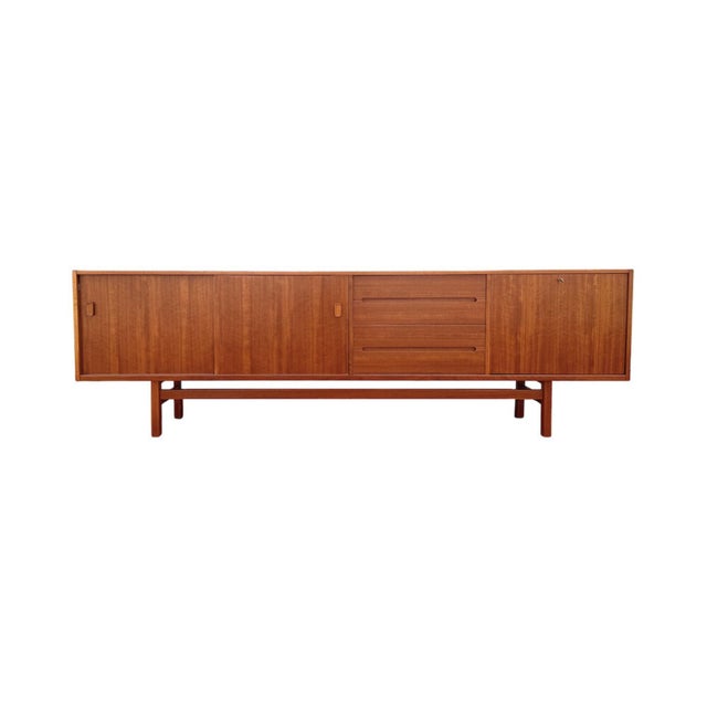 Vintage mid-century Swedish modern teak credenza designed by Nils Jonsson in 1961 for Hugo Troeds, Sweden. This monumental...