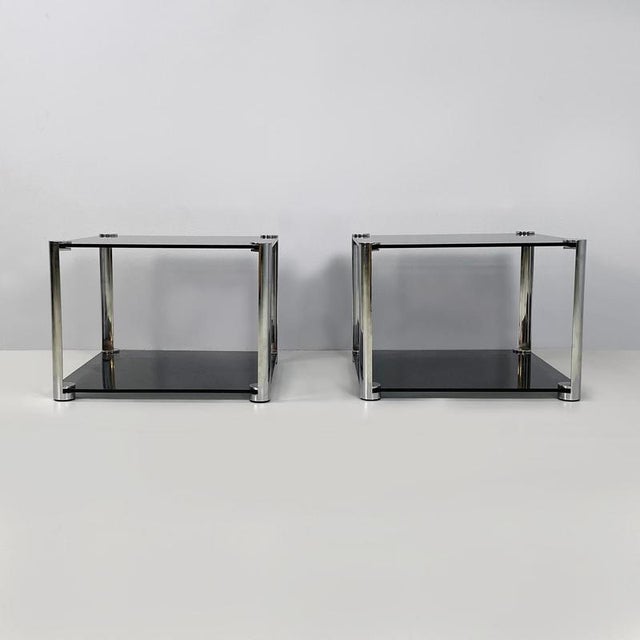 Italian modern Coffee tables in smoked glass and chromed metal, 1980s Pair of coffee tables with double squared shelves in...