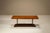 A restrained silhouette combined with warm mahogany veneer gives this coffee table a quiet architectural presence....