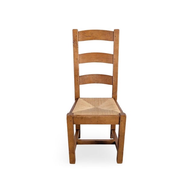 We are offering a beautiful set of four French oak chairs from the 1950s-60s for sale. The chairs feature hand-woven rush...
