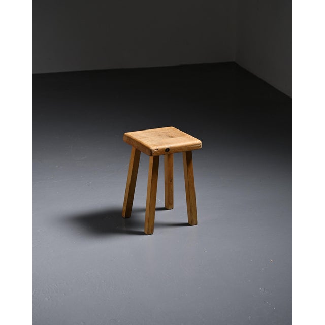 Solid pine stool with a square seat and four-legged base. It was designed for the Les Arcs ski resort, to which Charlotte...